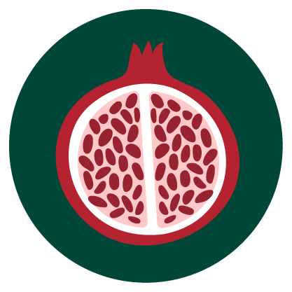 A close-up photo of a group of halved pomegranates showing their bright red seeds.